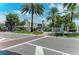 A street view in St. Armands Circle, showing statues, palm trees and shops at 845 Benjamin Franklin Dr # 104, Sarasota, FL 34236