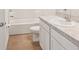 Bright bathroom with a white vanity, white toilet and a shower-tub combo at 8600 Milestone Dr, Sarasota, FL 34238