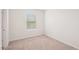 Bedroom featuring neutral carpet, base trim, light paint and a bright window at 8600 Milestone Dr, Sarasota, FL 34238