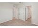 Carpeted bedroom with a large closet and several access doors at 8600 Milestone Dr, Sarasota, FL 34238