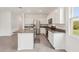 Modern kitchen featuring stainless steel appliances, granite countertops, and white cabinetry at 8600 Milestone Dr, Sarasota, FL 34238