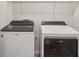 Laundry room featuring new model washer and dryer units with wire rack shelving at 8600 Milestone Dr, Sarasota, FL 34238