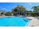Community pool featuring ample seating, pergolas, and manicured landscaping creating an ideal outdoor retreat at 8600 Milestone Dr, Sarasota, FL 34238