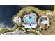 Aerial view of community amenities: pool, playground, fire pit and clubhouse alongside a lake at 9215 Royal River Cir, Parrish, FL 34219
