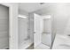 Bright bathroom features white shower, vanity, and mirrors leading to the bedroom at 9215 Royal River Cir, Parrish, FL 34219