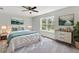 Bright bedroom with a ceiling fan, large window, and tastefully decorated with paintings at 9215 Royal River Cir, Parrish, FL 34219