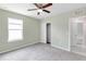Bright bedroom with ceiling fan, closet, and neutral carpet at 9215 Royal River Cir, Parrish, FL 34219