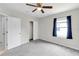 Bedroom with neutral walls, plush carpet, closet, and ceiling fan at 9215 Royal River Cir, Parrish, FL 34219
