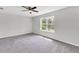 Spacious bedroom featuring a ceiling fan and a sunlit window overlooking the backyard at 9215 Royal River Cir, Parrish, FL 34219