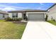 Charming one-story home featuring a well-maintained front yard and an attached two-car garage at 9215 Royal River Cir, Parrish, FL 34219