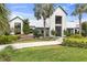 Brightwood Pavilion clubhouse boasts a modern farmhouse design with lush landscaping and inviting entrance at 9215 Royal River Cir, Parrish, FL 34219