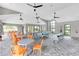 Bright community game room with ping pong and pool tables, seating, and ceiling fans at 9215 Royal River Cir, Parrish, FL 34219