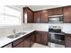 Kitchen features stainless appliances, modern counters and cherry cabinets at 9215 Royal River Cir, Parrish, FL 34219
