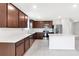 Kitchen features stainless appliances, modern counters and cherry cabinets at 9215 Royal River Cir, Parrish, FL 34219