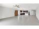Bright living room features gray tile floors and an open design leading into the kitchen at 9215 Royal River Cir, Parrish, FL 34219