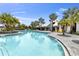 Community pool with inviting blue water, lots of seating and a playground at 9215 Royal River Cir, Parrish, FL 34219