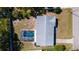 Aerial view of the home showcasing a well-maintained roof, large screened-in pool, and a spacious yard at 923 Dawn St, Venice, FL 34285
