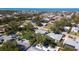 Desirable neighborhood aerial view featuring mature trees, lush landscaping, and a peek of the stunning ocean in the distance at 923 Dawn St, Venice, FL 34285