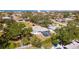 Single-story home with a screened-in pool, surrounded by lush landscaping and mature trees for privacy at 923 Dawn St, Venice, FL 34285