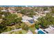 Aerial view of the property showcasing a screened-in pool, lush landscaping, and fenced yard for outdoor entertaining at 923 Dawn St, Venice, FL 34285