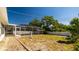 Lush backyard featuring a screened-in pool, verdant lawn, pristine white fence, and ample room for outdoor activities at 923 Dawn St, Venice, FL 34285