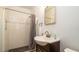 Bathroom featuring shower with white tile, gray floor, and vanity sink at 923 Dawn St, Venice, FL 34285