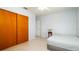 Cozy bedroom features a ceiling fan and closet with wooden doors at 923 Dawn St, Venice, FL 34285