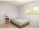 Cozy bedroom with an air mattress, side table with lamp, one window and neutral carpeting at 923 Dawn St, Venice, FL 34285