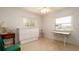 Bright bedroom featuring a Murphy bed, two windows, ceiling fan, and side tables at 923 Dawn St, Venice, FL 34285
