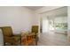 Dining area looking to bathroom and sunroom, plus glass table and chairs at 923 Dawn St, Venice, FL 34285