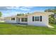 Beautiful white single-story home with dark shutters and a well-maintained green lawn at 923 Dawn St, Venice, FL 34285