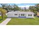 Charming single-story home featuring a well-manicured lawn and a freshly painted white exterior at 923 Dawn St, Venice, FL 34285
