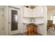 Cute kitchen nook with barstools, cabinets, and access to the outdoors via a glass-paned door at 923 Dawn St, Venice, FL 34285