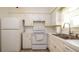 Efficient white kitchen featuring modern appliances and ample counter space for cooking and meal preparation at 923 Dawn St, Venice, FL 34285