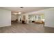 Open-concept living room with dining area and sunroom with tiled floors at 923 Dawn St, Venice, FL 34285