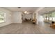 Spacious and bright living room featuring wood look flooring, and tons of natural light throughout at 923 Dawn St, Venice, FL 34285