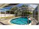 Enjoy the Florida lifestyle in this screened-in pool with brick pavers and a tranquil backyard view at 923 Dawn St, Venice, FL 34285