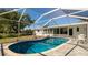 Enjoy swimming in this gorgeous screened-in pool surrounded by a lush backyard for the ultimate in outdoor living at 923 Dawn St, Venice, FL 34285