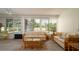 Sunroom with views of the pool, with comfortable seating for guests at 923 Dawn St, Venice, FL 34285