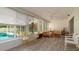 Bright sunroom with views of the pool, with seating for multiple guests at 923 Dawn St, Venice, FL 34285