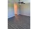 Bright bedroom featuring durable wood floors, ceiling fan, and closet space providing both comfort and functionality at 10668 Lake Montauk Dr, Riverview, FL 33578