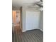 Bedroom showcasing wood floors, a ceiling fan, and closet with an open doorway view to an ensuite bathroom at 10668 Lake Montauk Dr, Riverview, FL 33578