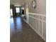 Hallway displaying stylish architectural design, featuring a built-in entertainment center, and tile floors at 10668 Lake Montauk Dr, Riverview, FL 33578