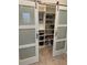 Sliding door reveals walk-in pantry, maximizing kitchen storage with adjustable shelves at 10668 Lake Montauk Dr, Riverview, FL 33578