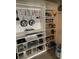 Bright pantry with white shelving, cookware rack, and storage for kitchen essentials at 10668 Lake Montauk Dr, Riverview, FL 33578