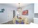 Dining area featuring glass-top table with rattan chairs and modern light fixture at 117 7Th N St # 14, Bradenton Beach, FL 34217