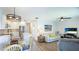 Open living area featuring updated floors, kitchen with island, and comfortable seating at 117 7Th N St # 14, Bradenton Beach, FL 34217