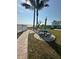 Scenic picnic area with blue tables, palm trees, and views of the waterfront at 117 7Th N St # 14, Bradenton Beach, FL 34217