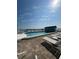 Rooftop pool with blue skies, lounge chairs, and distant views, perfect for relaxation at 117 7Th N St # 14, Bradenton Beach, FL 34217
