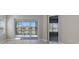 Bright living room featuring a screen patio overlooking serene lake views at 11717 Great Brook Ln, Parrish, FL 34219